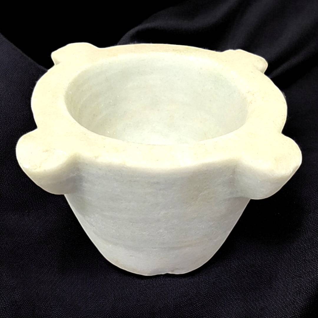 Mortero de mármol antiguo y compacto con diseño decorativo, ideal para cocina rústica o vintage. Perfecto para mezclar ingredientes con estilo.