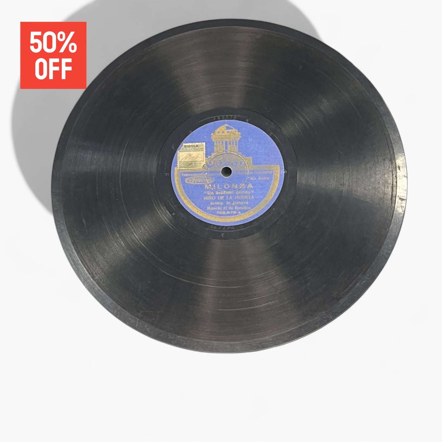 Disco de pizarra antiguo con grabación de Milonga, sello Odeon azul, ideal para decoración vintage de hogar o colección.