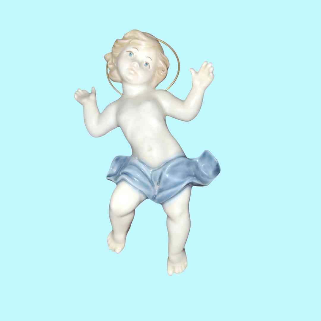 Figura Niño Jesús en porcelana MIRETE, edición limitada, con detalles en azul y halo dorado. Arte sacro para decoración y colección.