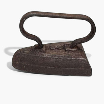 Plancha antigua de hierro macizo con mango curvo, pieza única coleccionable ideal para decoración vintage en el hogar.