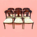 Conjunto completo del lote de 6 sillas de caoba, alineadas para mostrar su uniformidad y estilo clásico.