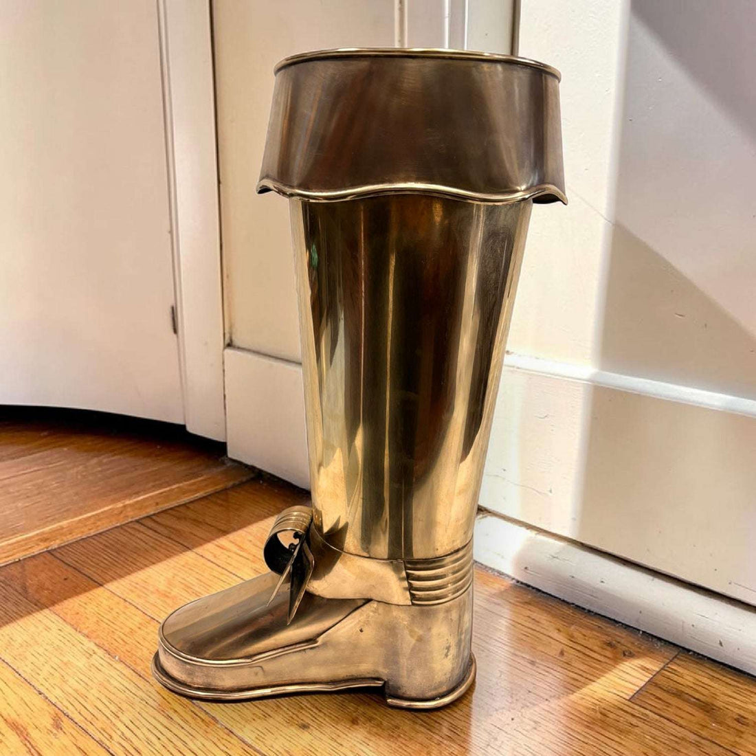 En las imágenes se aprecia un diseño muy singular con forma de bota alta, trabajado en metal plateado con acabado envejecido. 