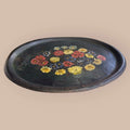 Esta Bandeja antigua de tole, realizada en metal pintado, es una pieza decorativa con gran personalidad visual.