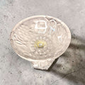 Base de la bombonera antigua de cristal con relieves florales y uvas, en forma de pedestal hexagonal, decorativa y elegante para colección.
