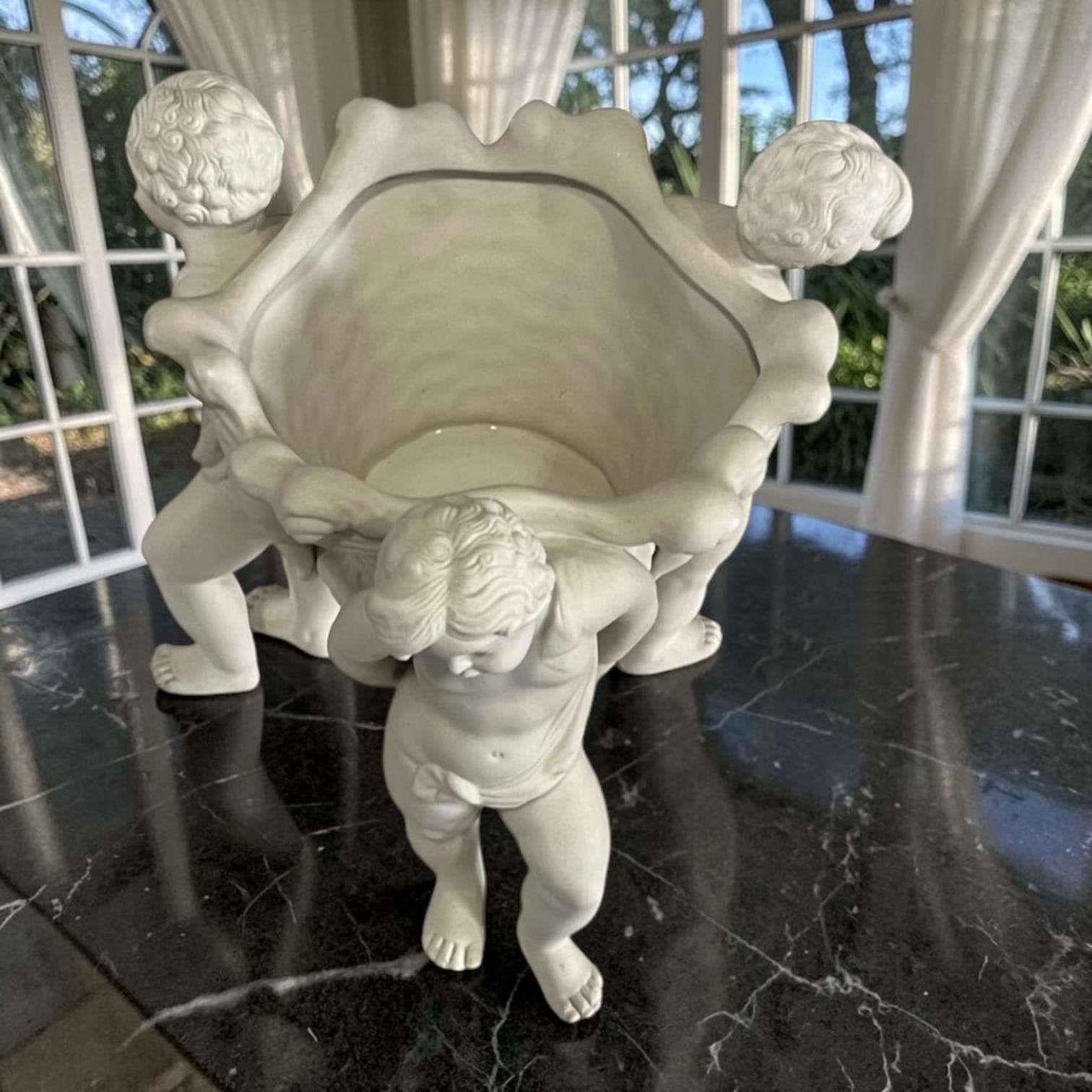 Perspectiva superior del centro de mesa de porcelana con querubines, resaltando la forma y detalles de los niños y la cesta, SKU: A-220.5