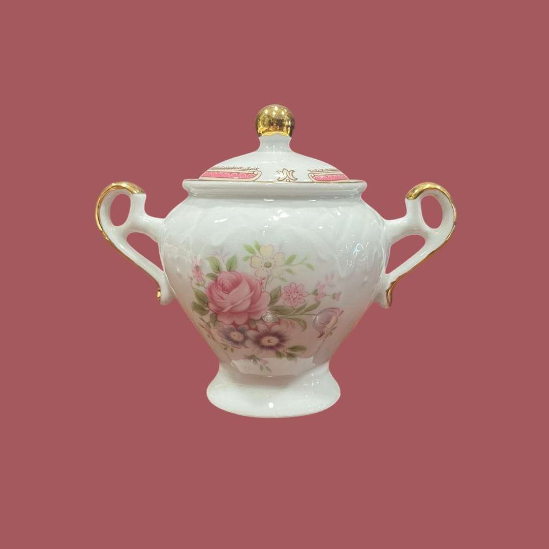 Azucarero TLimognes de porcelana fina con detalles únicos, decorado a mano con flores rosadas y bordes dorados, ideal para decoración elegante.