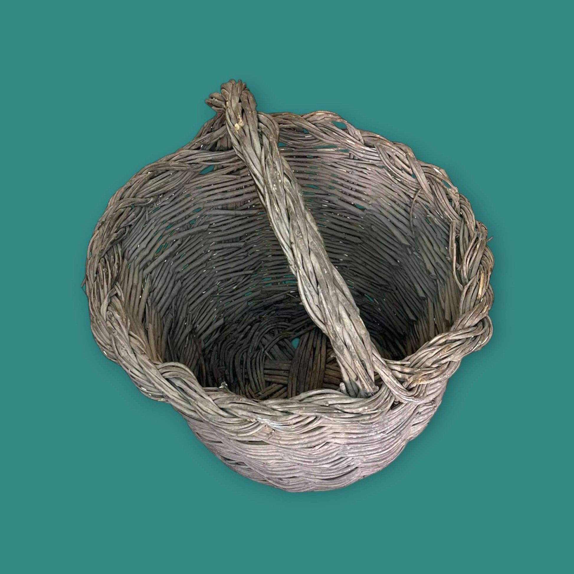 Canasta de mimbre hecha con baritas de olivo vista superior.