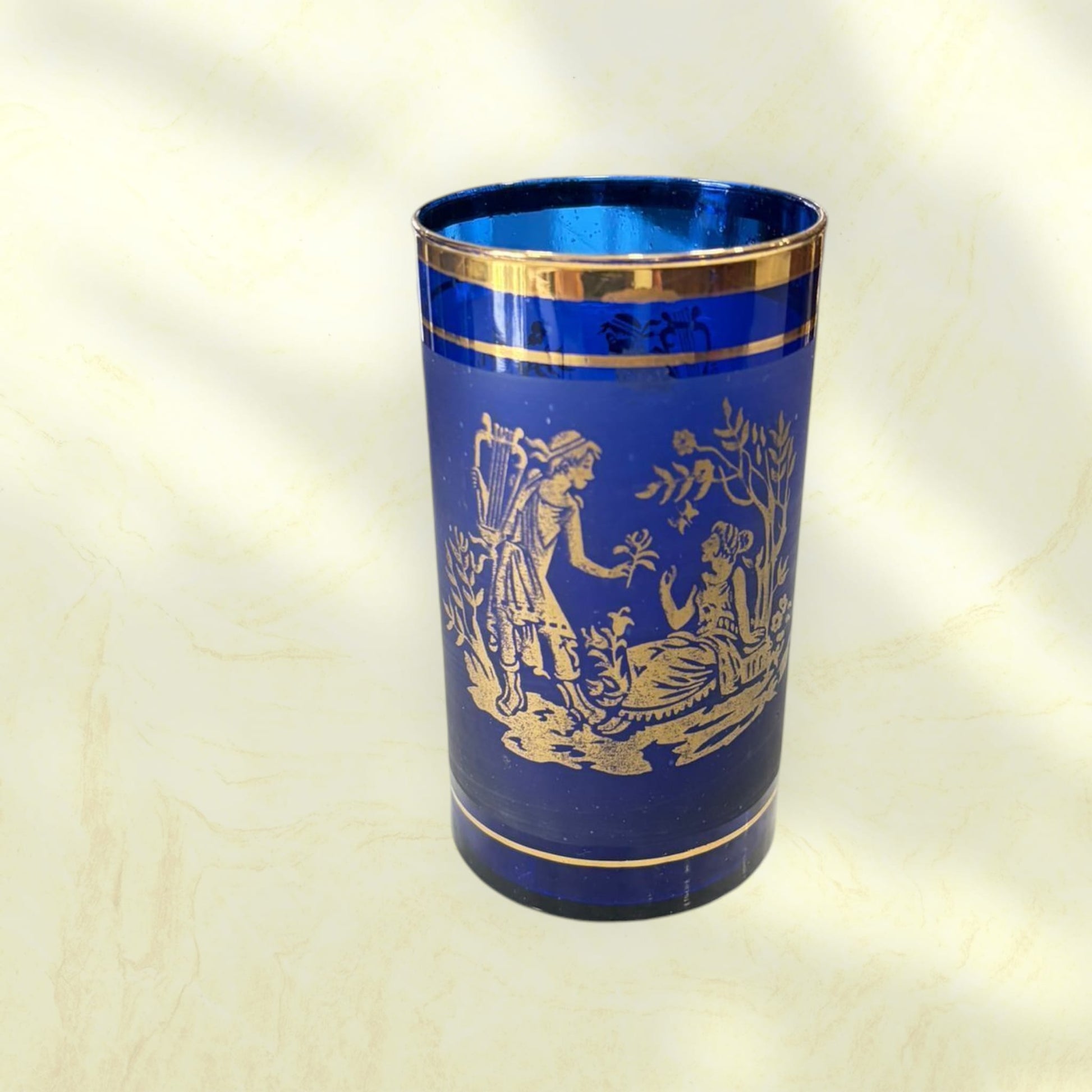 Botella y vasos de cristal cobalto decorados en oro.