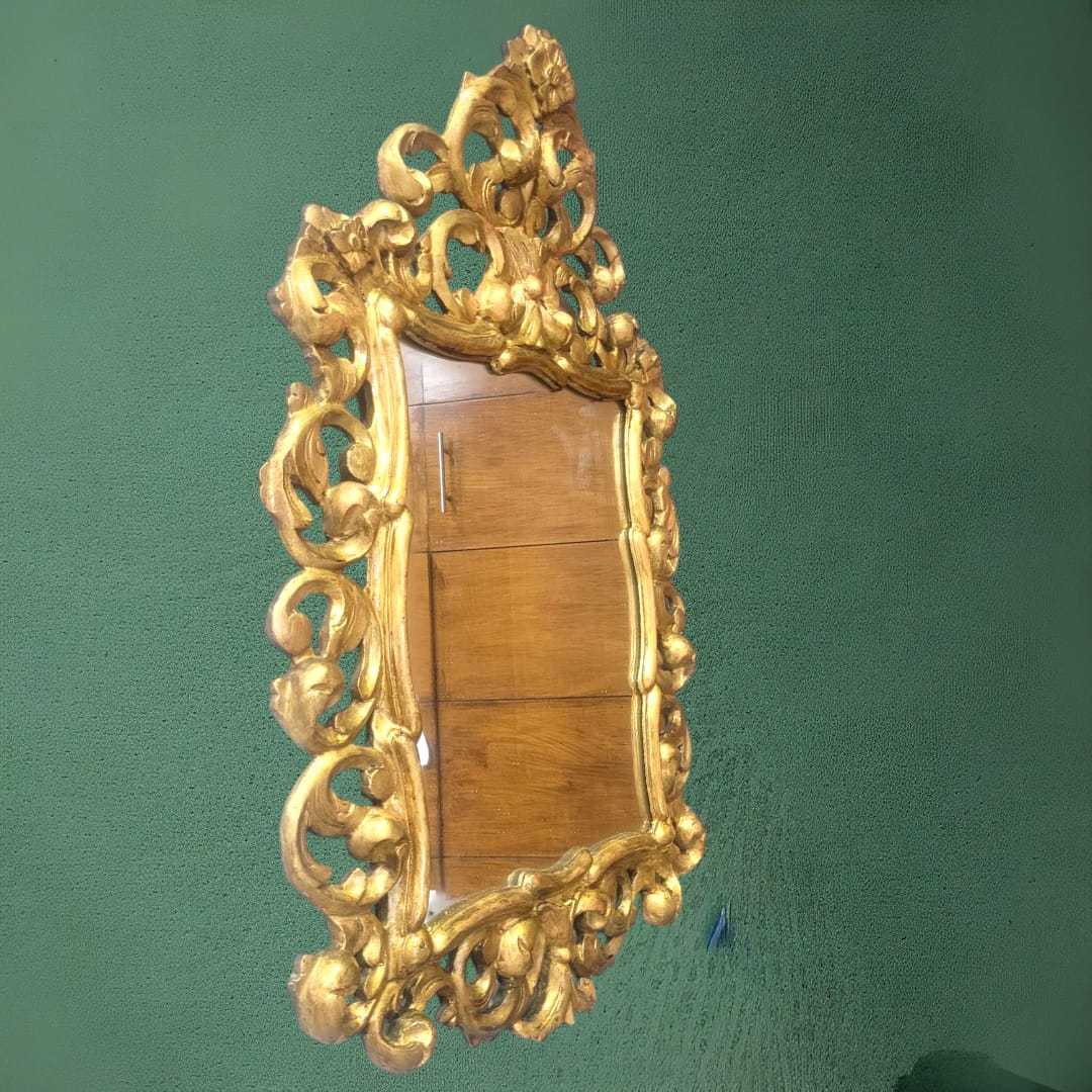 Espejo cornucopia ornamental con marco dorado tallado, ideal para una decoración elegante en interiores clásicos. Perfecto para salones o recibidores.