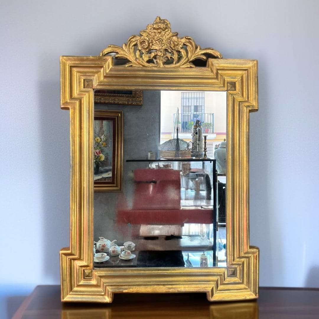 El Espejo tallado en madera pintado en dorado es una pieza que transforma cualquier ambiente en un espacio de elegancia atemporal. 