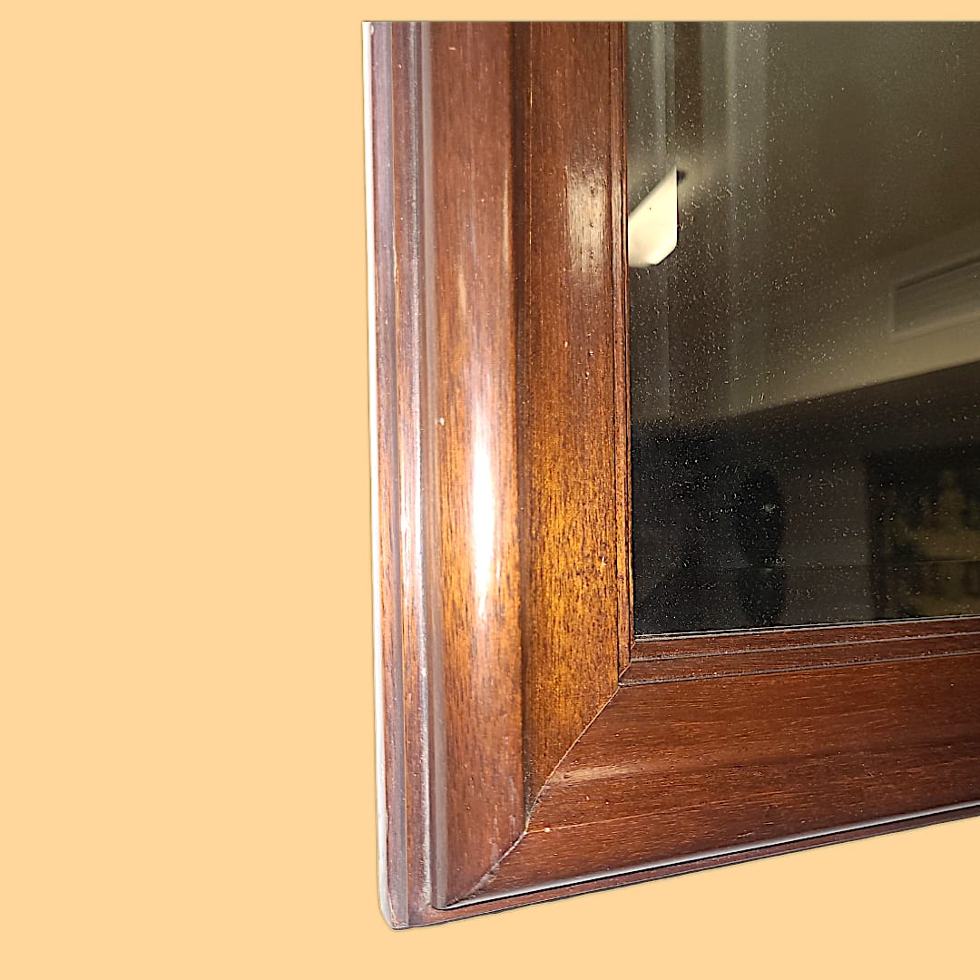 Imagen del espejo colgado en un salón, aportando amplitud y luminosidad al espacio.

