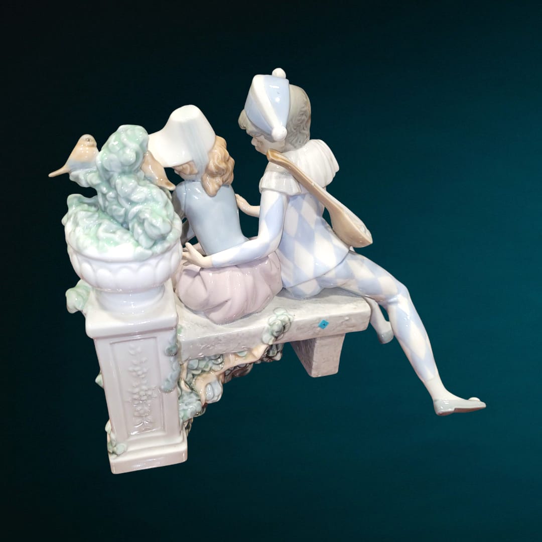 Figura de porcelana NAO LLADRÓ 'Amor precioso' con pareja romántica en banco, detalles refinados y acabado elegante. Ideal para decoración y coleccionistas.
