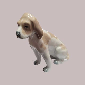 Perro de porcelana Lladró sentado en acabado brillante, figura decorativa ideal para coleccionistas y amantes de la decoración elegante.