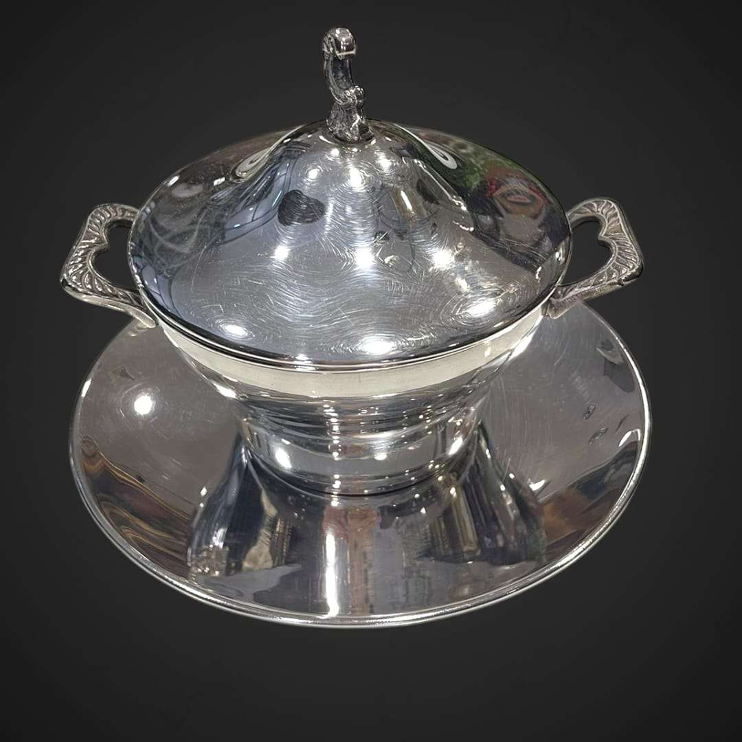 Azucarero de metal plateado con tapa y plato base.