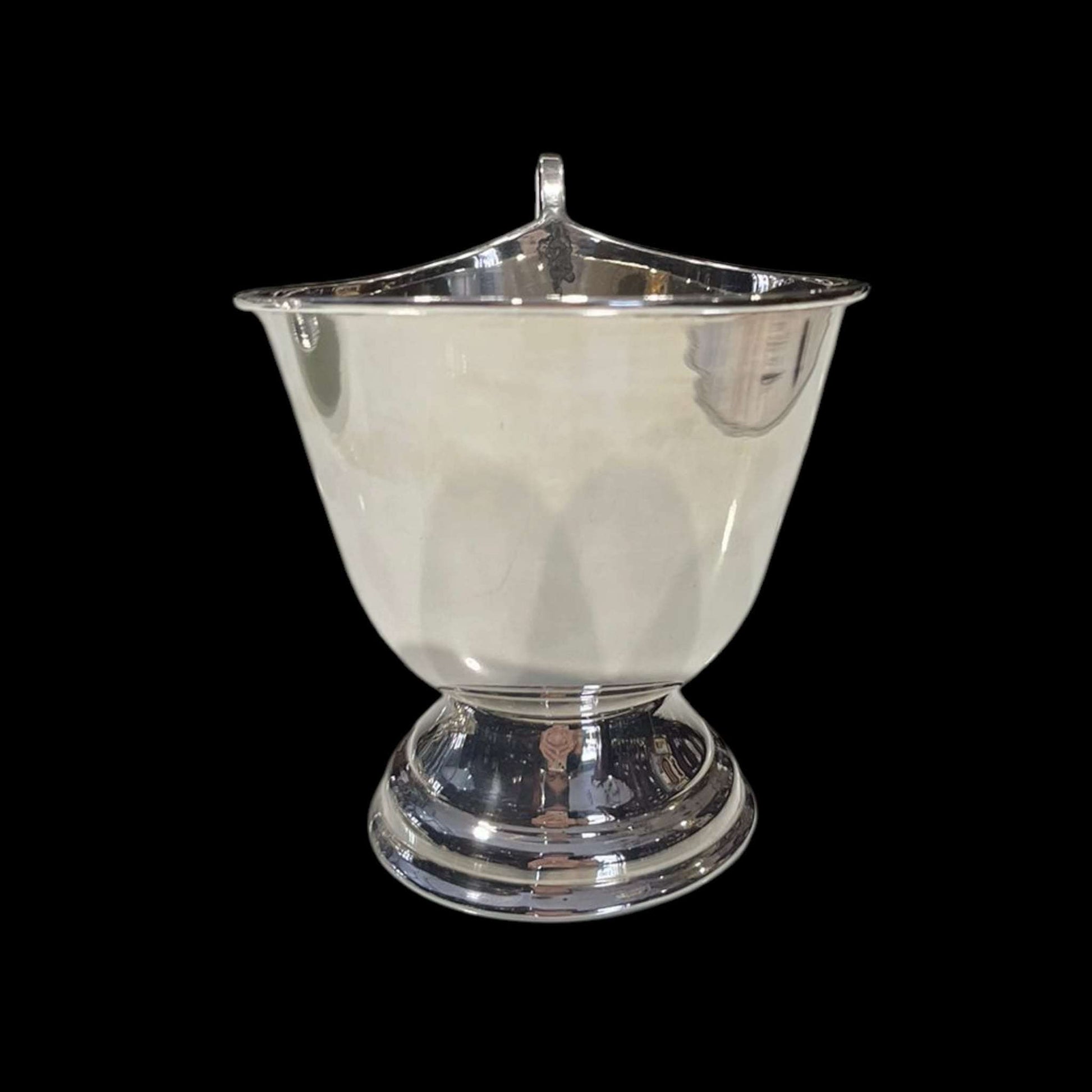 Detalle de la Salsera de metal plateado vista desde atrás.