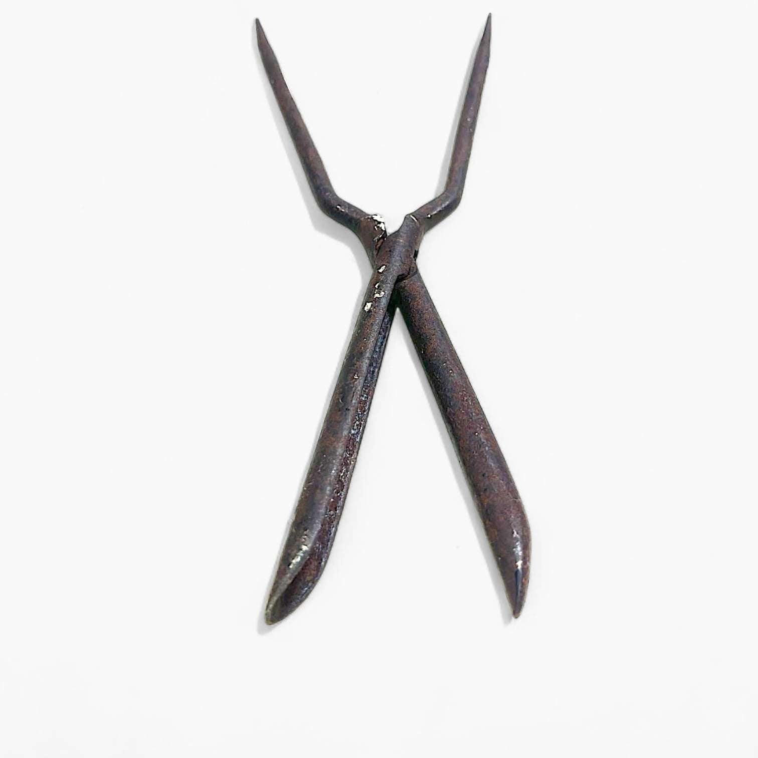 Herramienta antigua de hierro usada para tirabuzones.