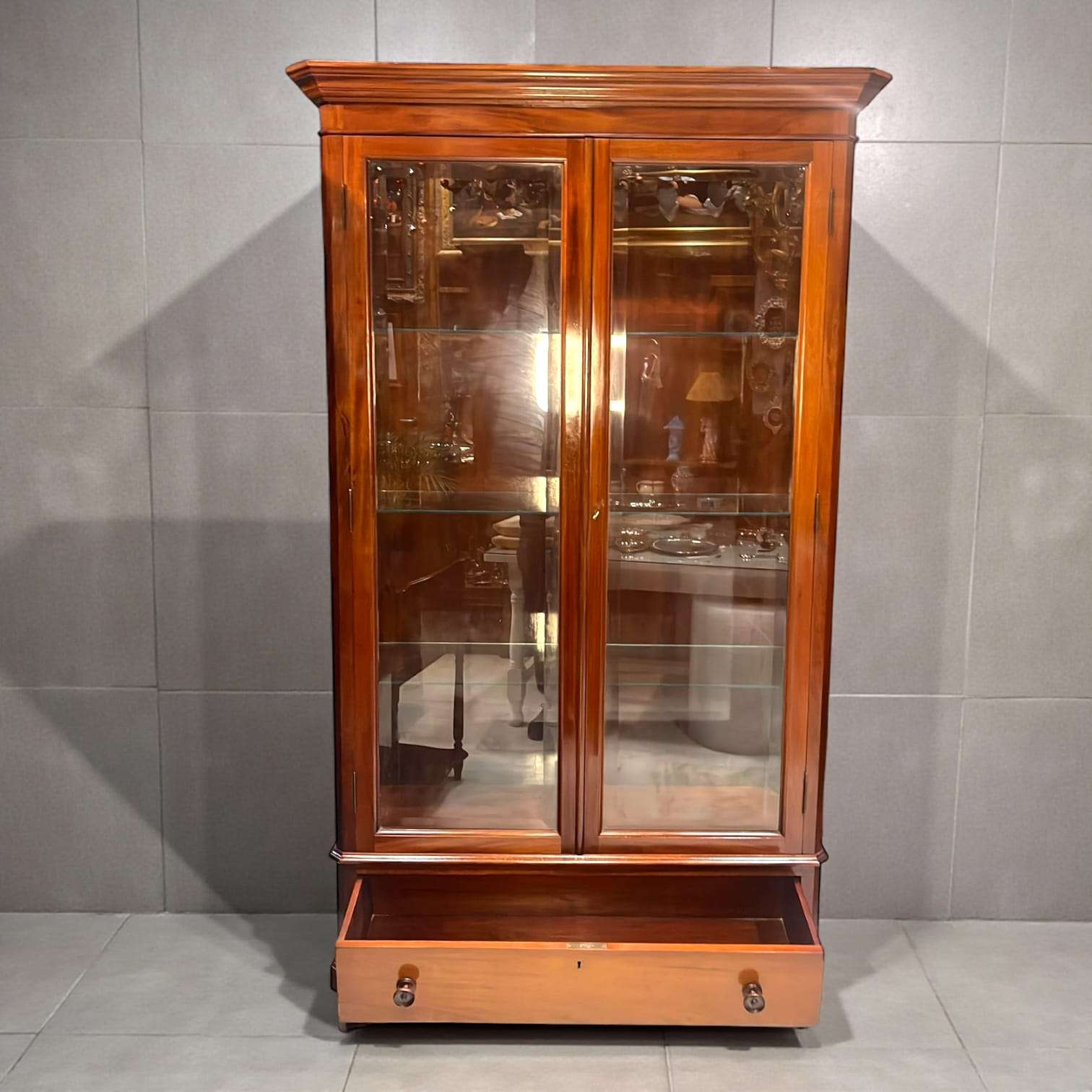 Vista lateral de la vitrina de caoba con cristal
