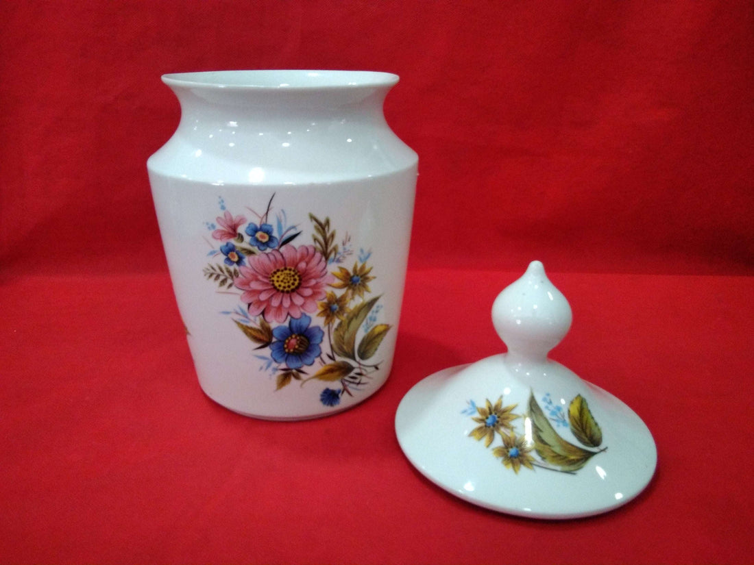 Tibor de porcelana de excelente calidad con diseño floral pintado a mano sobre fondo blanco, ideal para decoración clásica en el hogar.