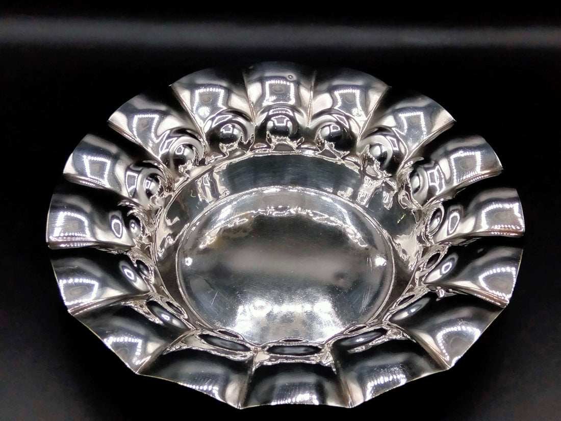 Plato de metal plateado con diseño ondulado, ideal para decoración elegante en el hogar. Parte de la colección Plato de Metal Plateado - Elegancia y Calidad.