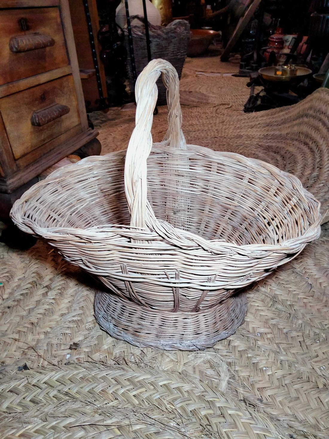 Cesteria de mimbre artesanal para flores con asa trenzada, ideal para decoración rústica en bodas y eventos. Cesta versátil para el hogar.