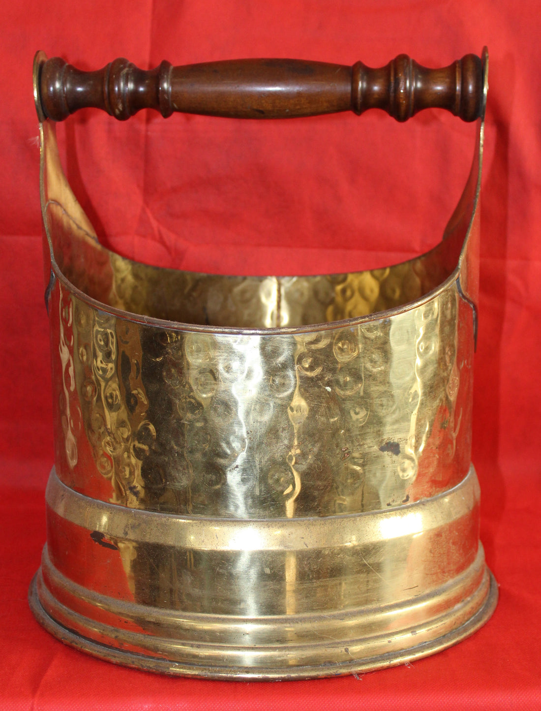 Revistero/leñera de metal resistente y elegante - vintage con acabado martillado en latón y asa de madera, ideal para decoración rústica.