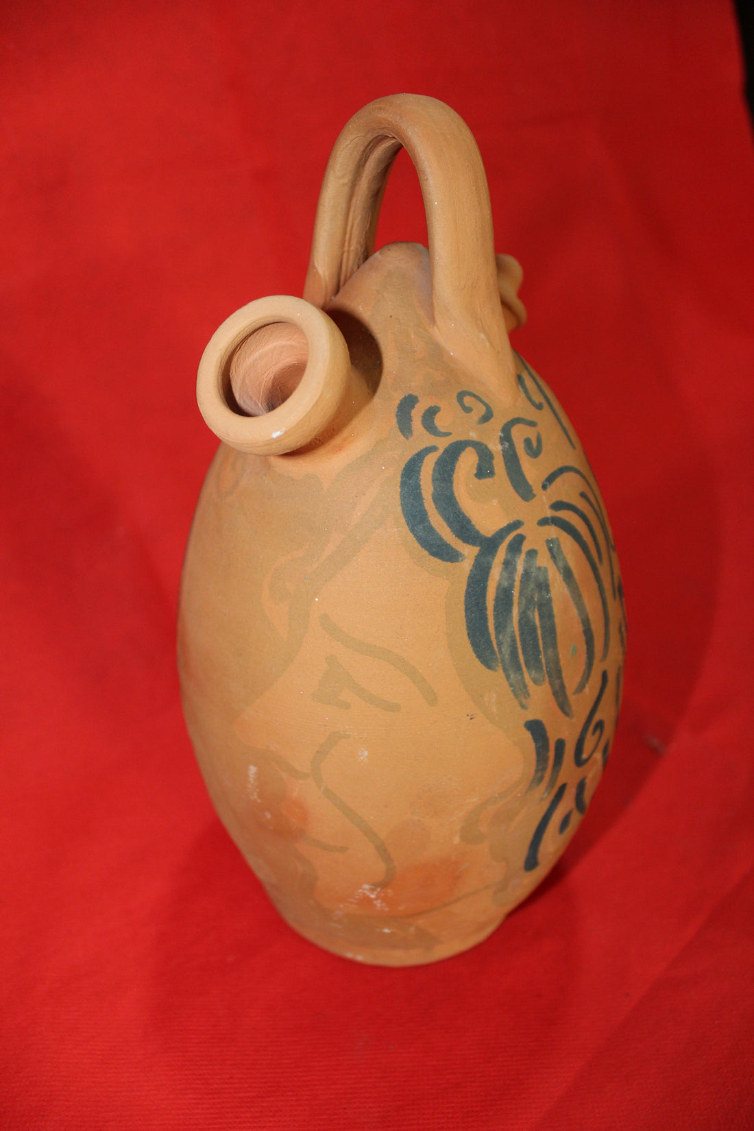 Botijo de cerámica Campo Real pintado a mano con diseño artístico de rostro femenino en tonos azules. Decoración tradicional para hogar y jardín.